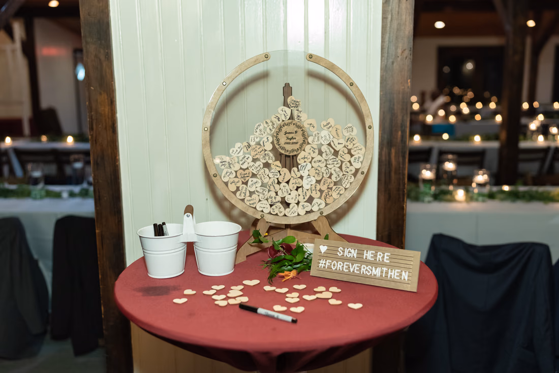 Wooden heart guest book drop box with a sign here note at Magnolia Plantation