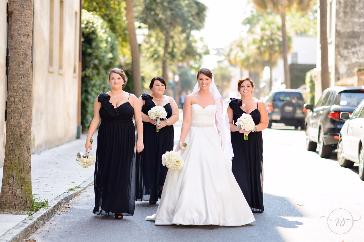 Bride walking down the downtown street with bridesmaids - Charleston, SC