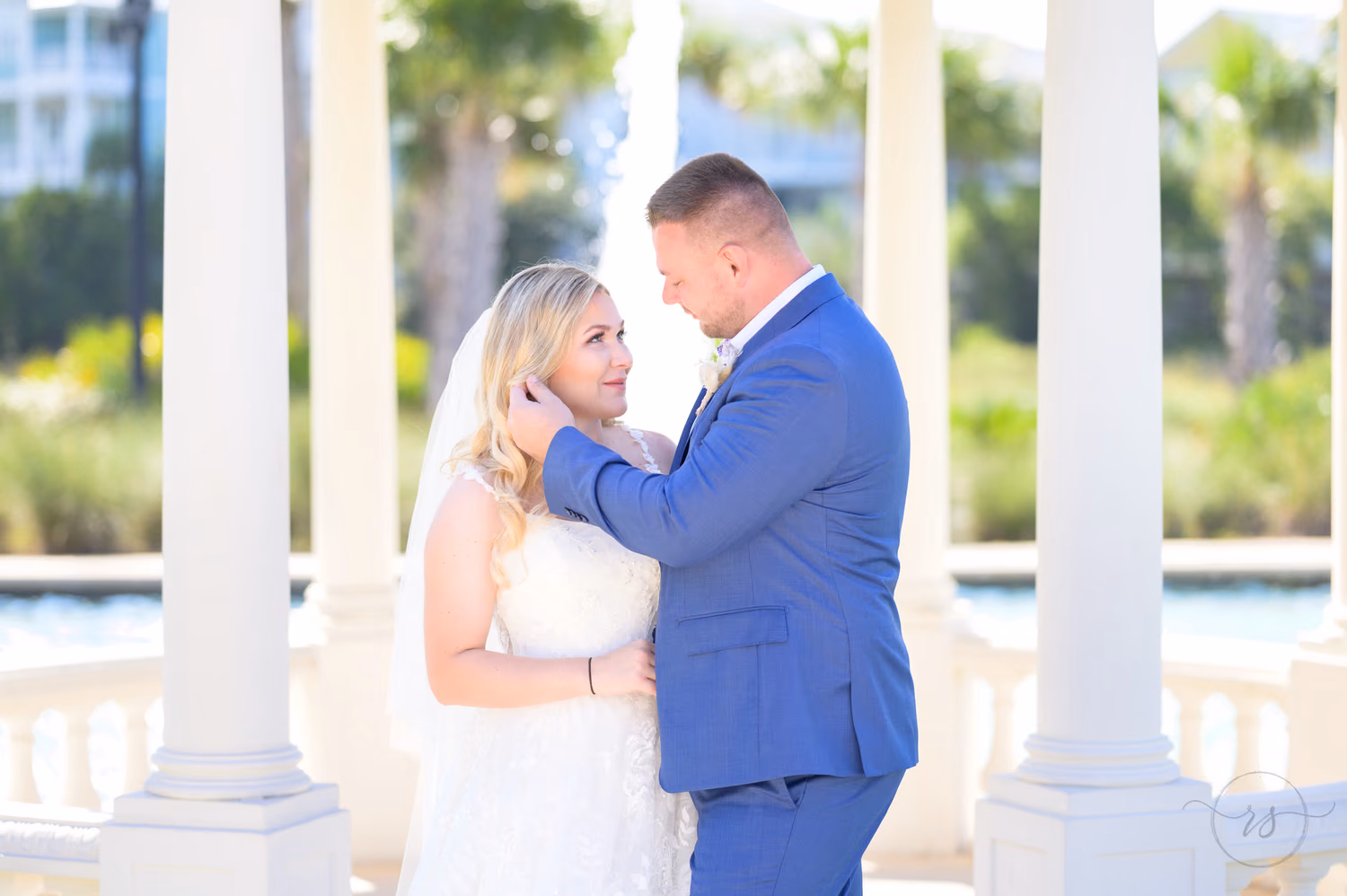 Groom pushing back bride's hair for a kiss - North Beach Resort & Villas