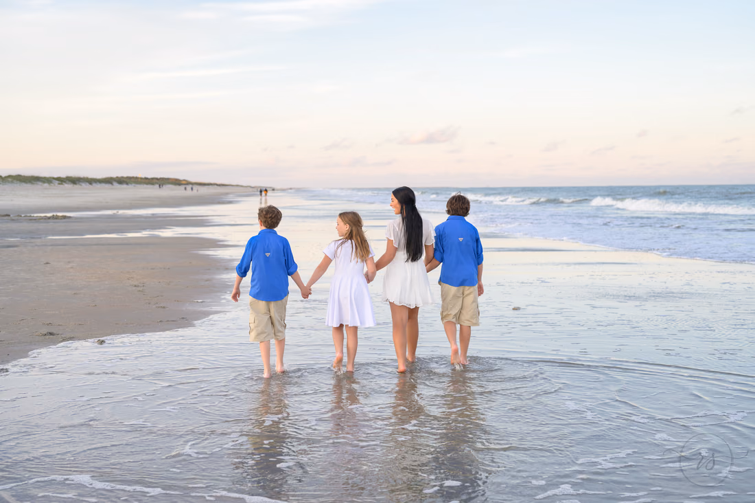 Brothers and sisters walking down the beach holding hands - Huntington Beach State Park