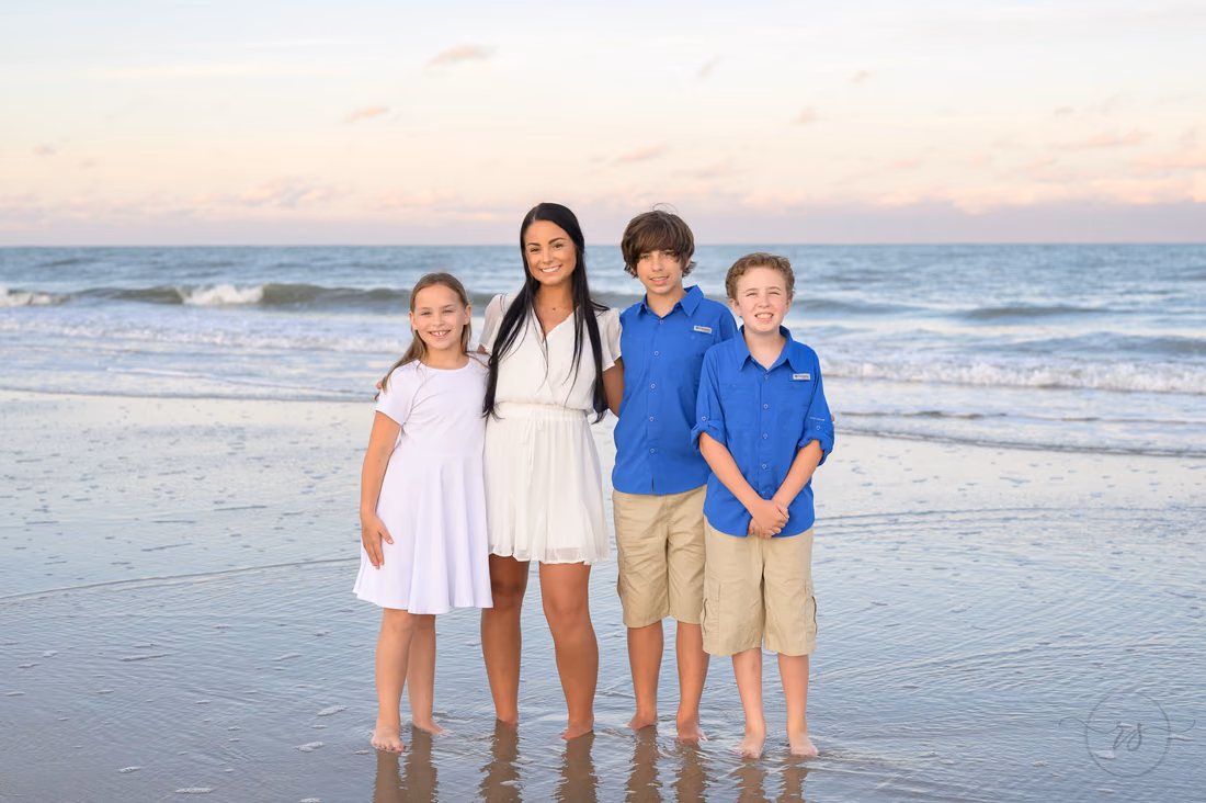 Kids standing by the ocean at sunset - Huntington Beach State Park