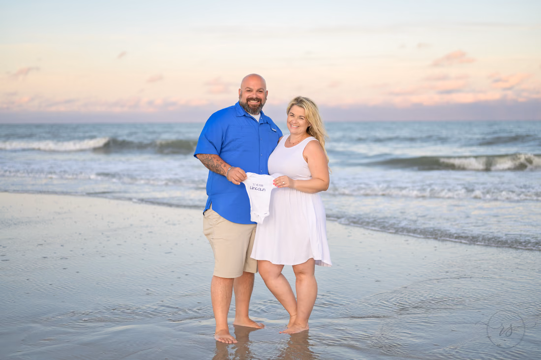 Maternity portraits holding up the baby name - Huntington Beach State Park