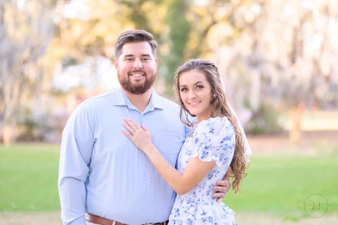 Close portrait of the couple, her hand with the engagement ring on his chest, at Caledonia Golf and Fish Club