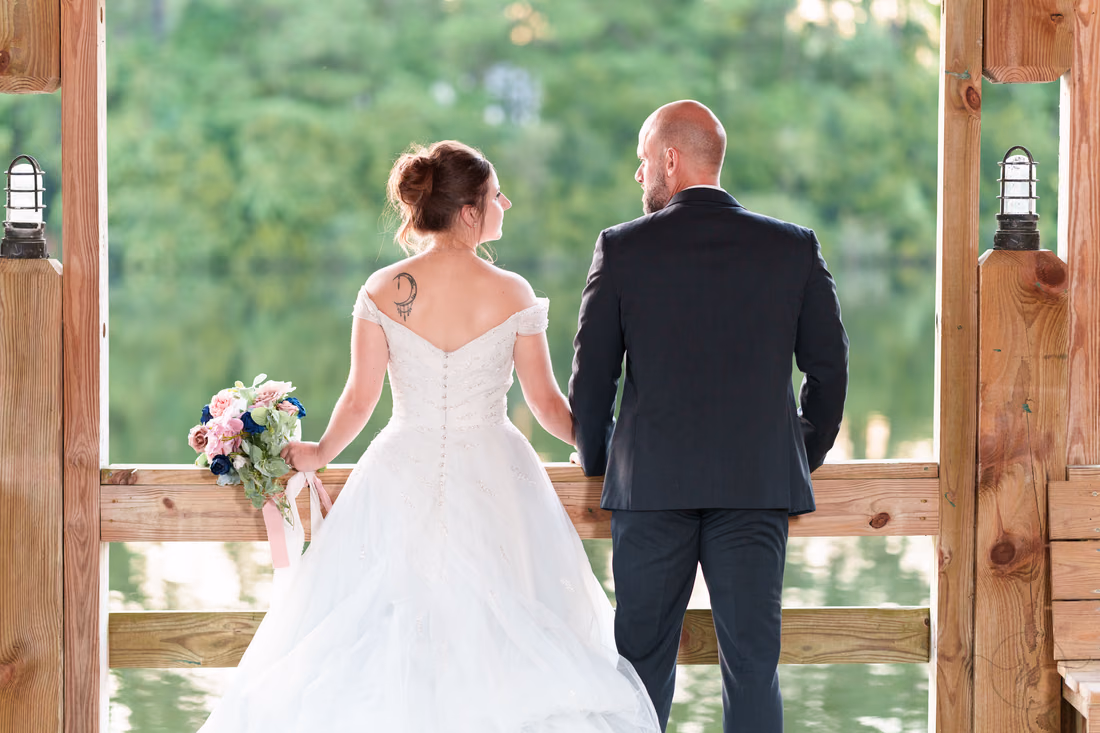 Bride and groom with rim light from the sunset on the gazebo - The Pavilion at Pepper Plantation