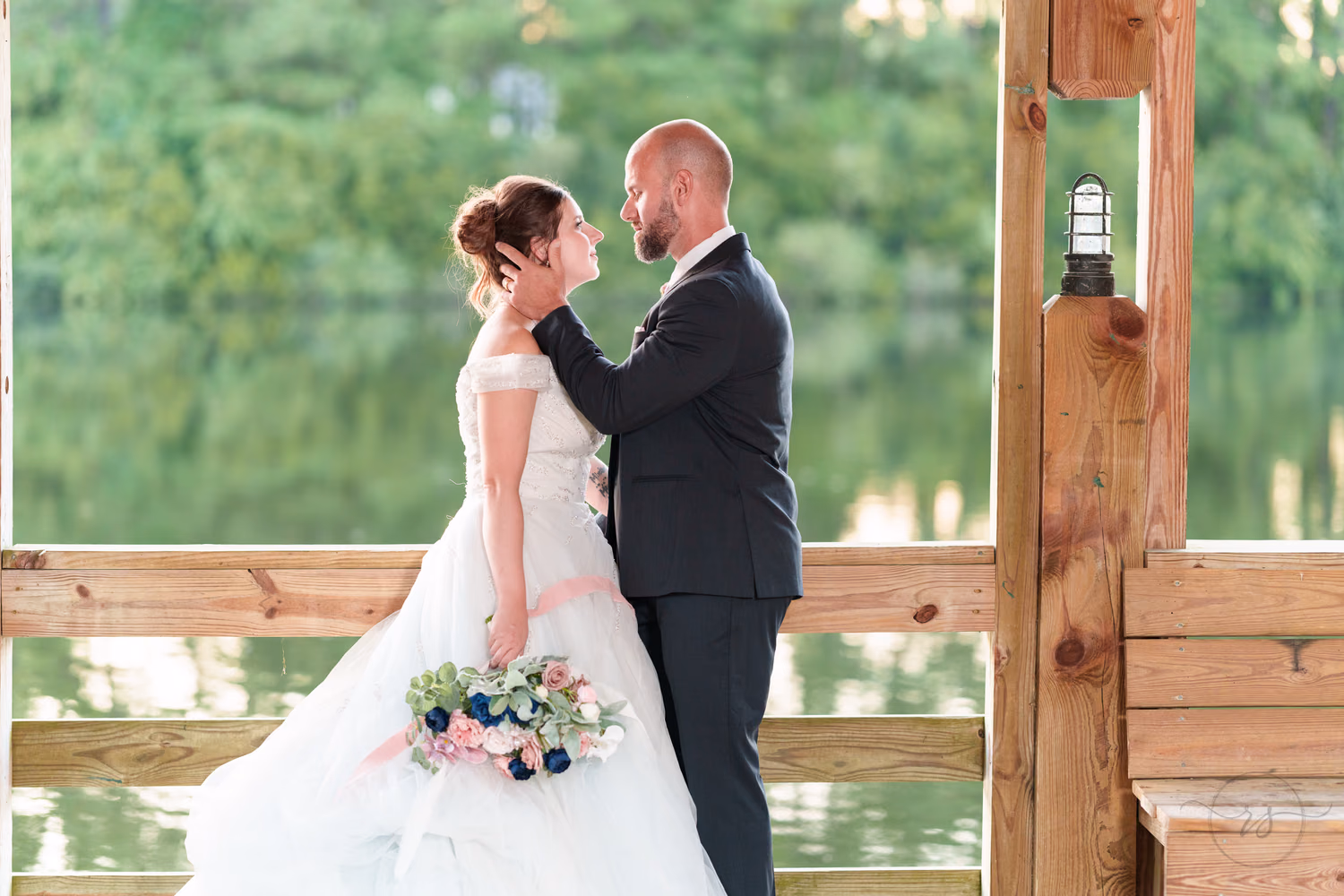 Bride and groom with rim light from the sunset on the gazebo - The Pavilion at Pepper Plantation
