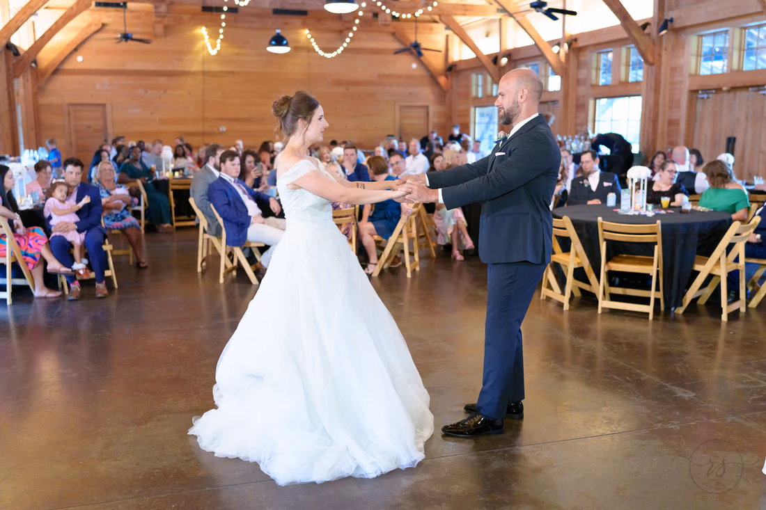 Groom twirling the bride at arm's length during their first dance - The Pavilion at Pepper Plantation