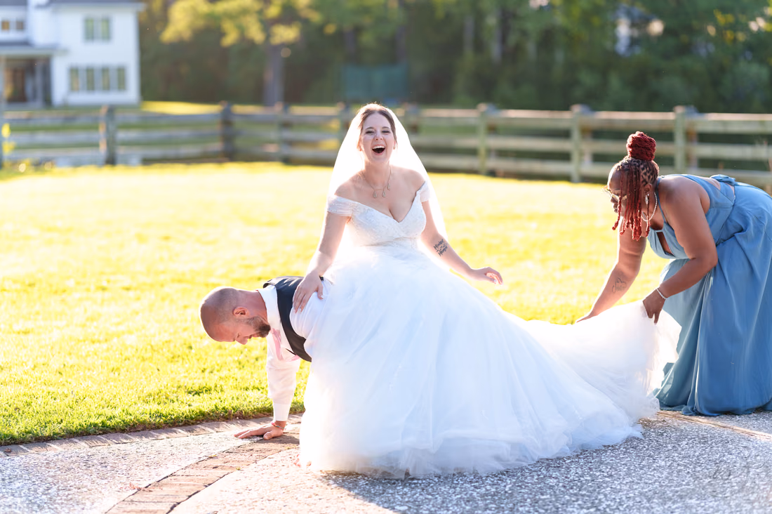 Groom doing pushups with bride on his back and falling - The Pavilion at Pepper Plantation