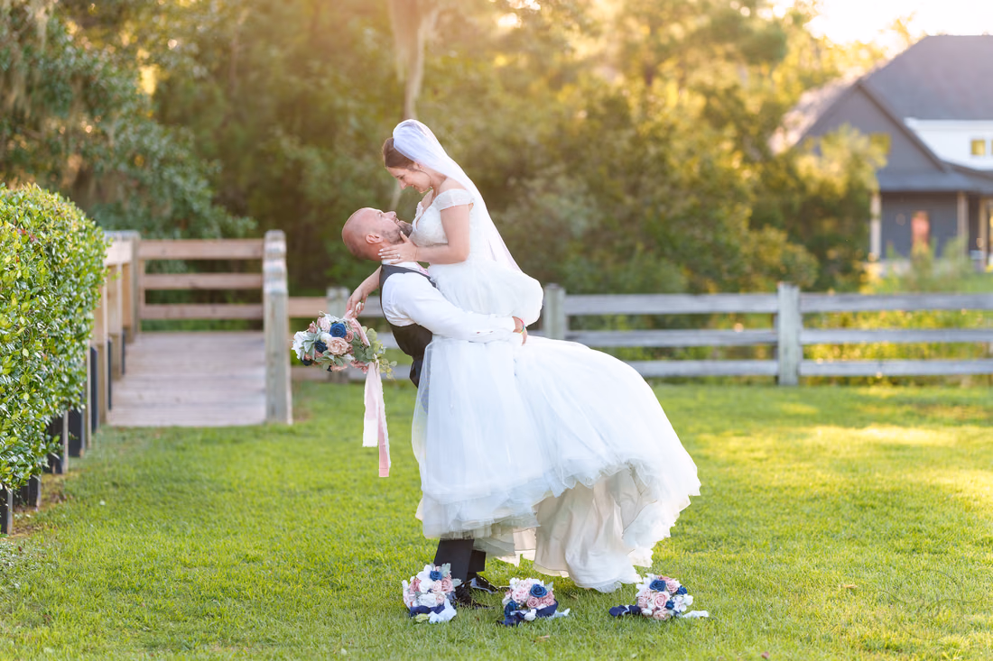Groom lifting bride into the air - The Pavilion at Pepper Plantation