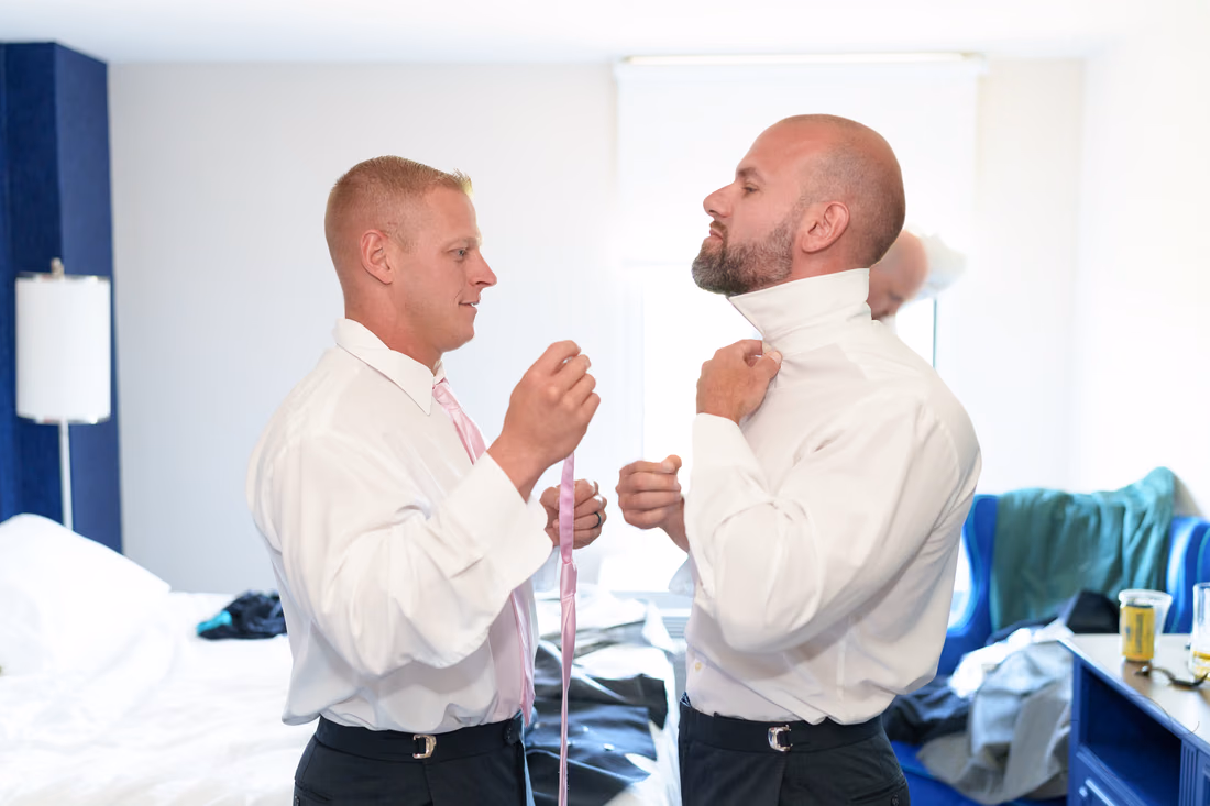Groomsmen tying their ties in the hotel room - Hotel Indigo
