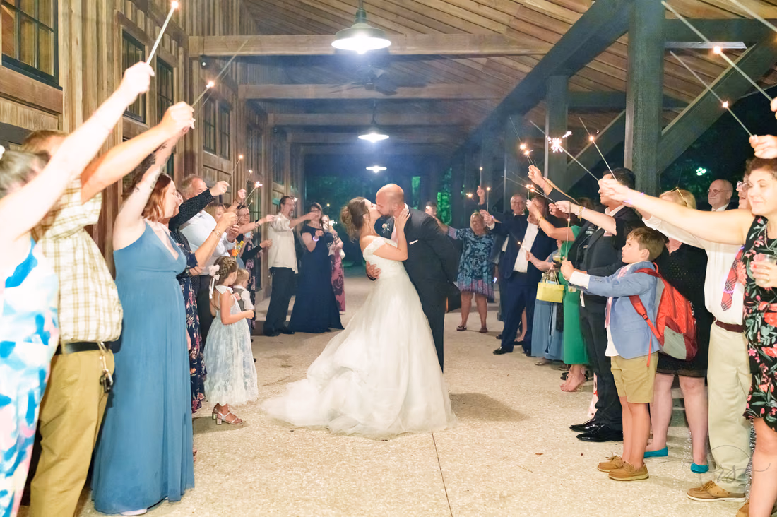 Bride and groom kissing under the sparklers during their exit - The Pavilion at Pepper Plantation