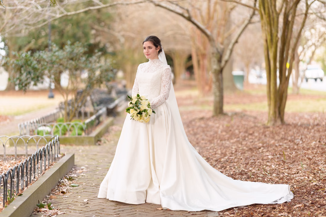 Bride looking off to the side on the park walkway - Marion Square Charleston