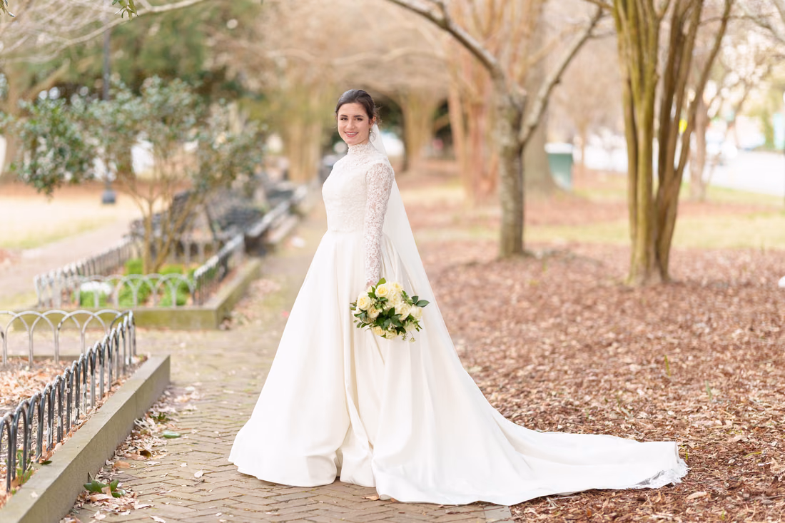 Bride smiling with her bouquet on the park walkway - Marion Square Charleston