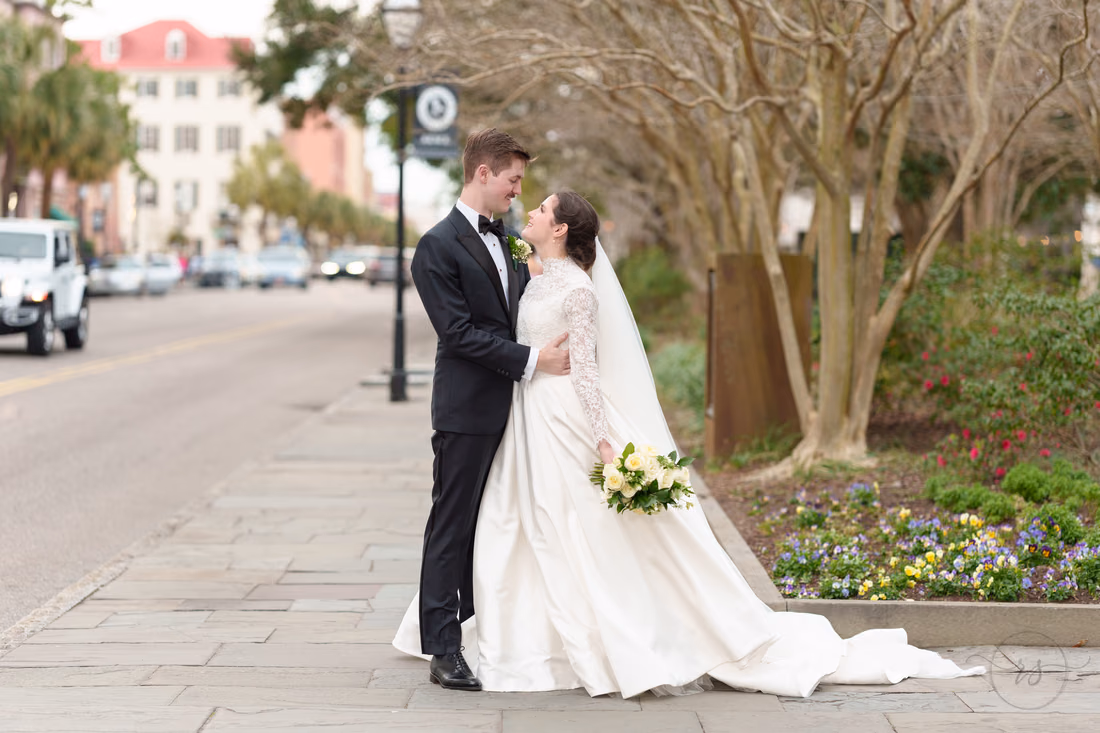 Bride and groom embracing by the busy street - Marion Square Charleston