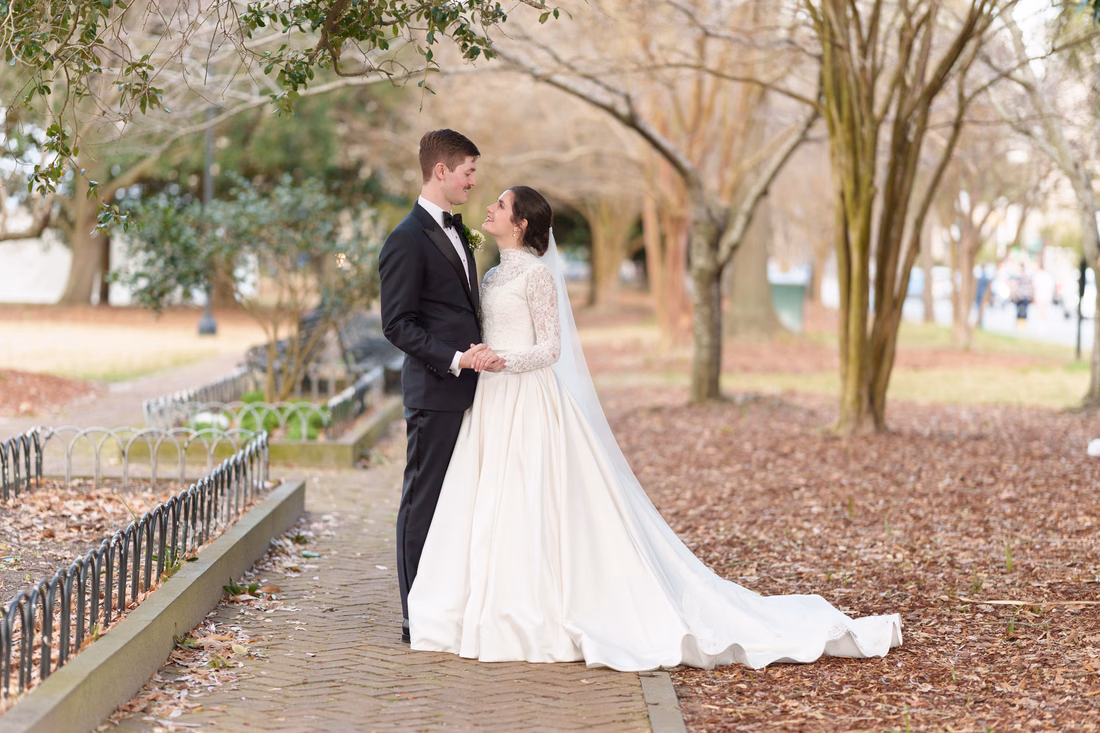Bride and groom facing each other on the walkway in the park - Marion Square Charleston