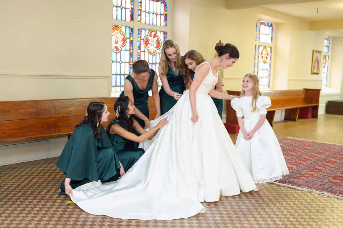 Bridesmaids and flower girl spreading out the bride's train - Cathedral of Saint John Charleston