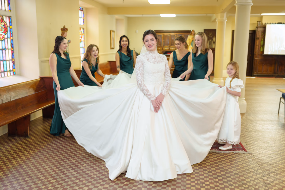 Bride standing with her long train spread across the floor - Cathedral of Saint John Charleston