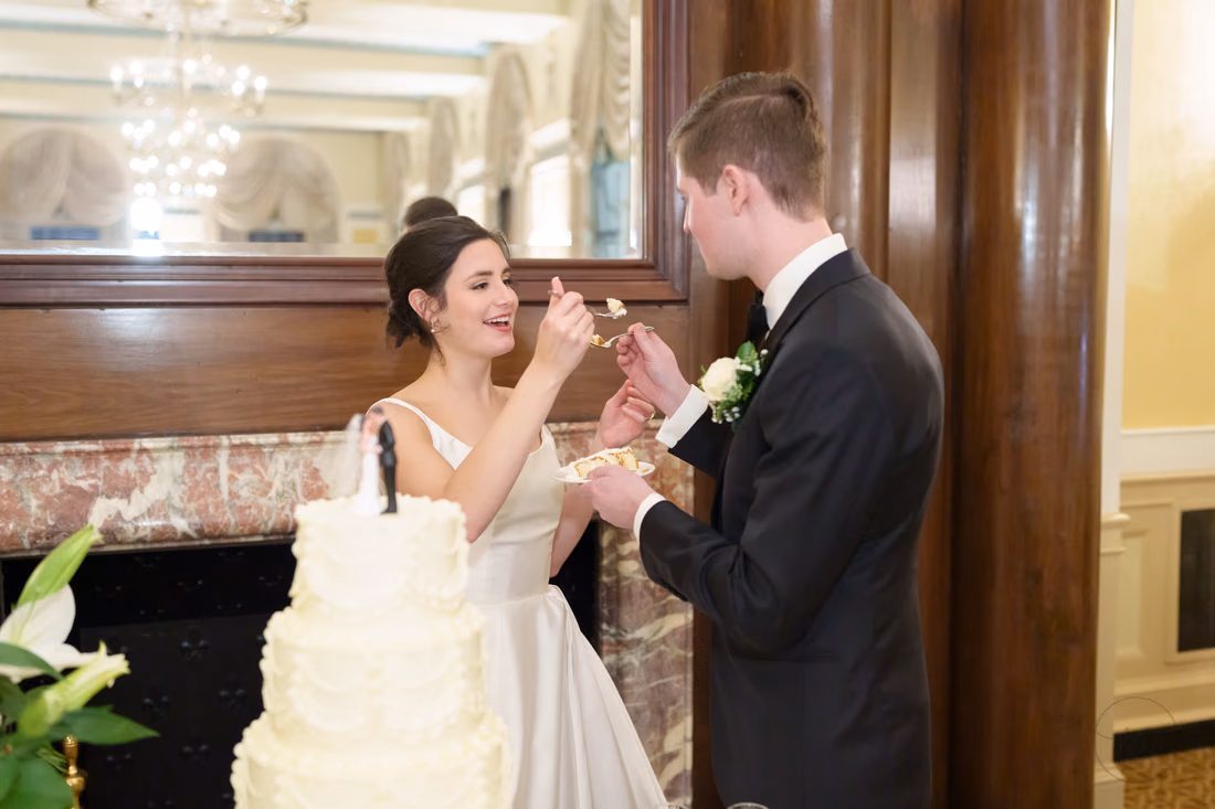 Bride feeding the groom a bite of cake - Francis Marion Charleston