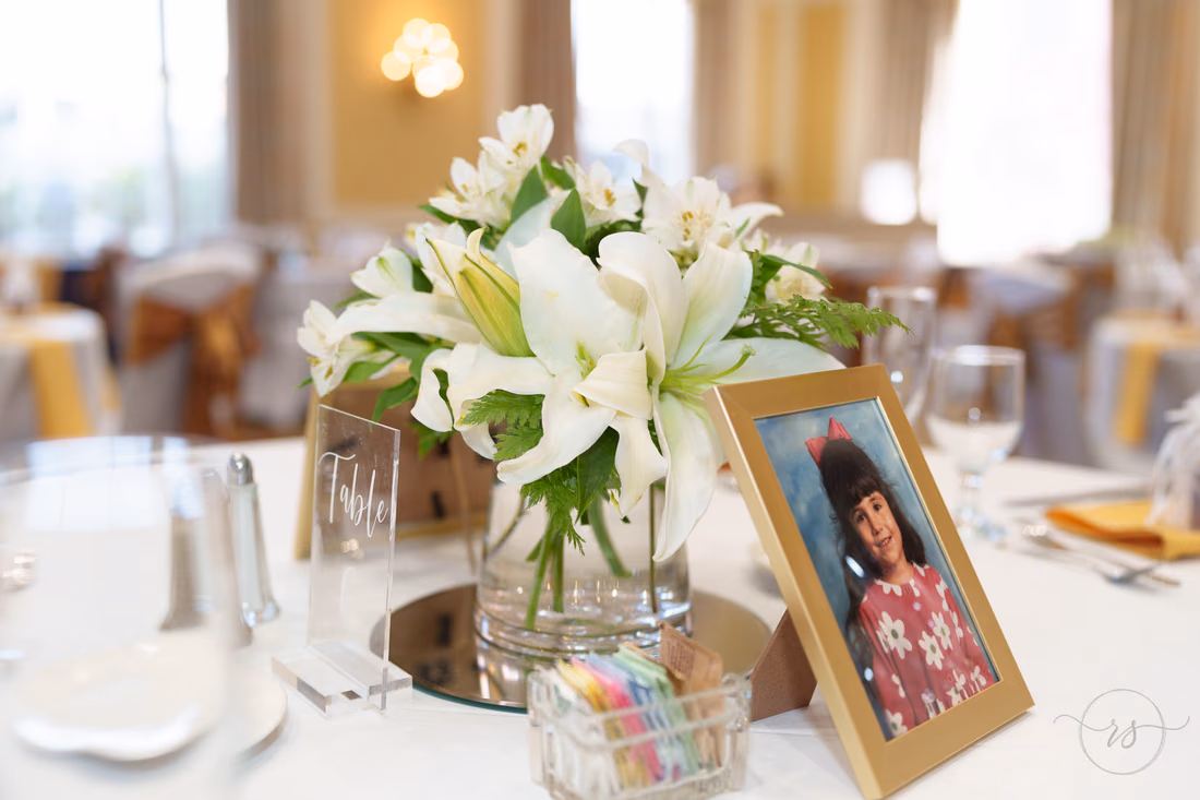 White lily centerpiece with a framed childhood photo - Francis Marion Charleston
