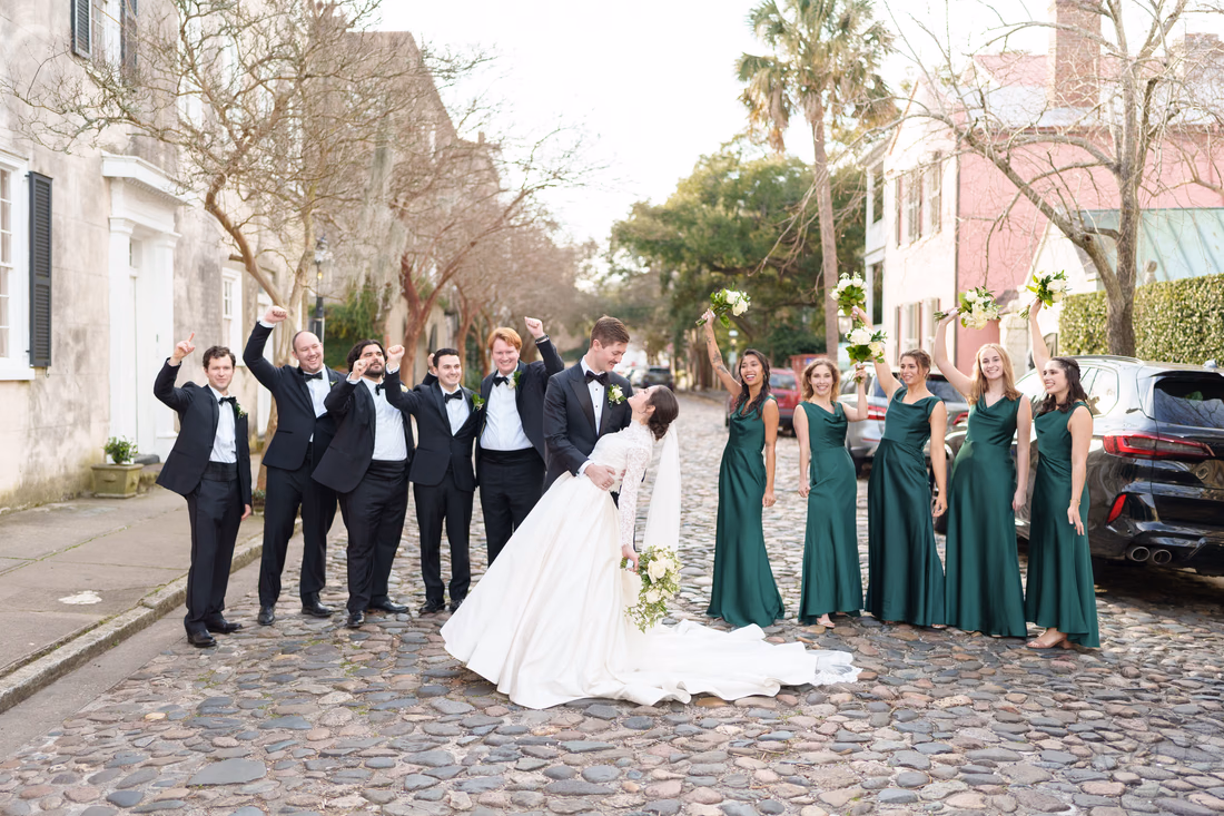 Dip back for a kiss with the bridal party cheering - Chalmers Street