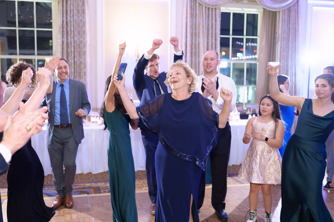 Guests cheering with fists in the air on the dance floor - Francis Marion Charleston