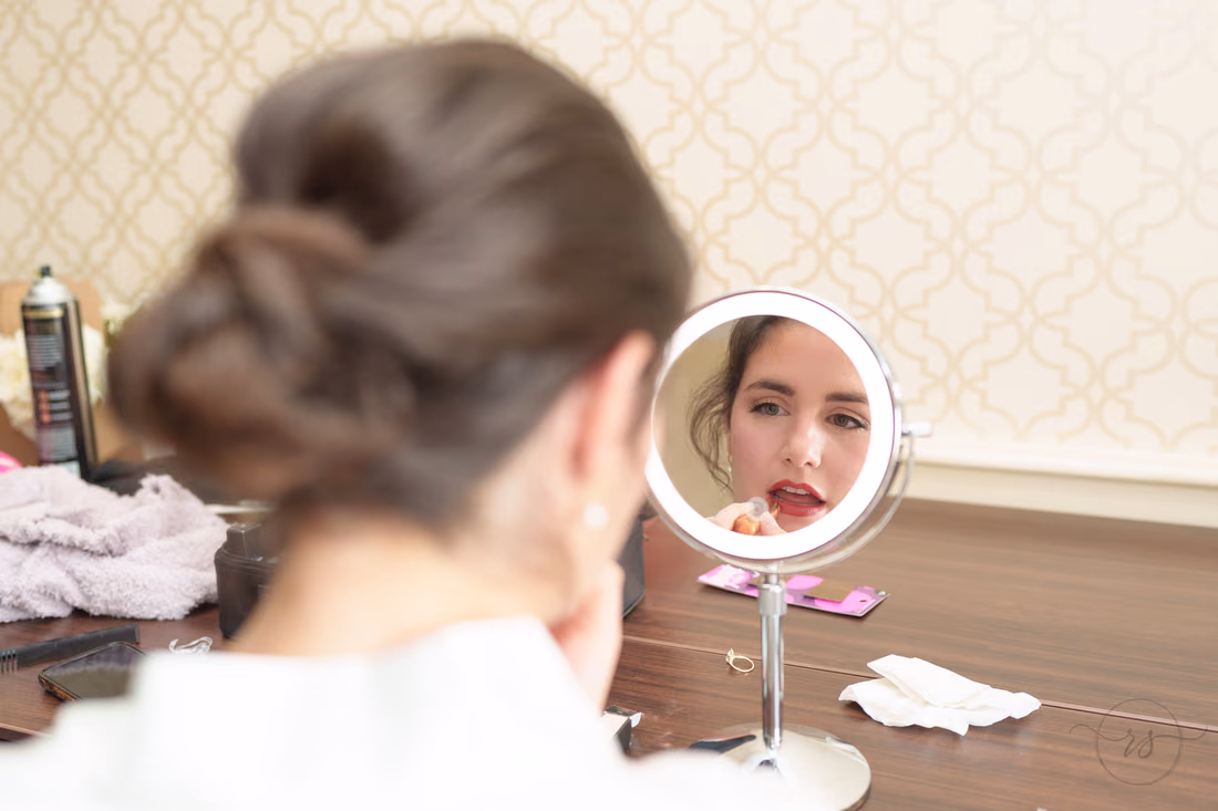 Bride putting on lipstick in a small round mirror - Francis Marion Charleston