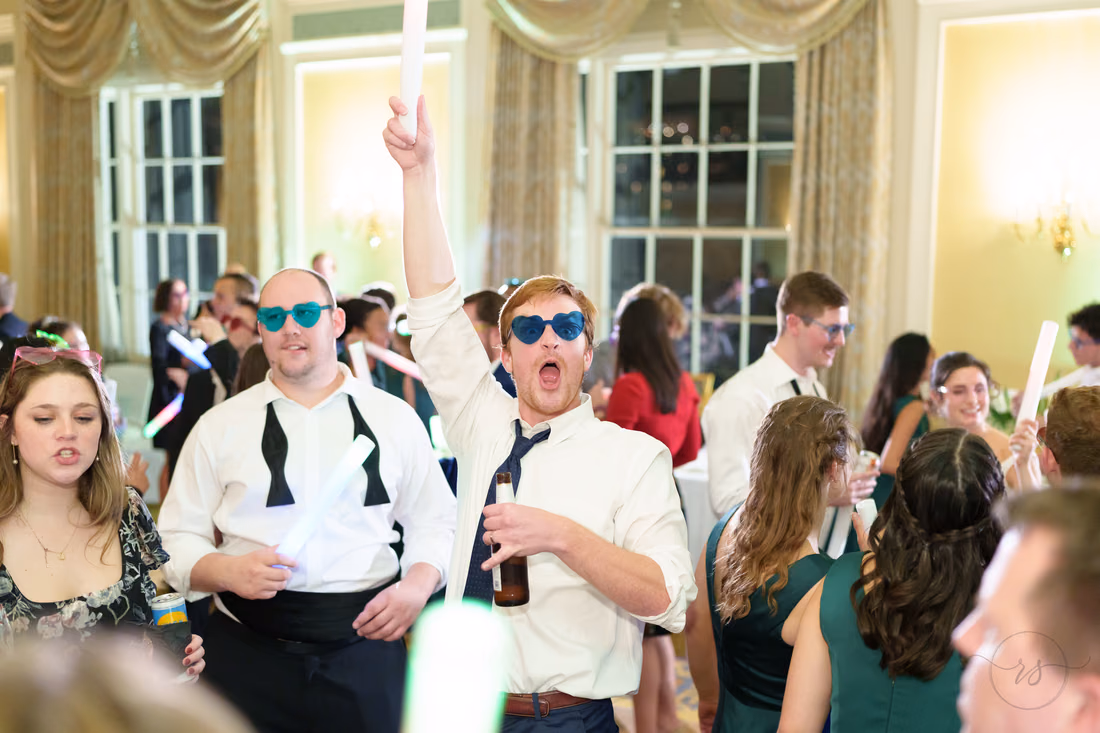 Guests in sunglasses shouting and waving light sticks - Francis Marion Charleston
