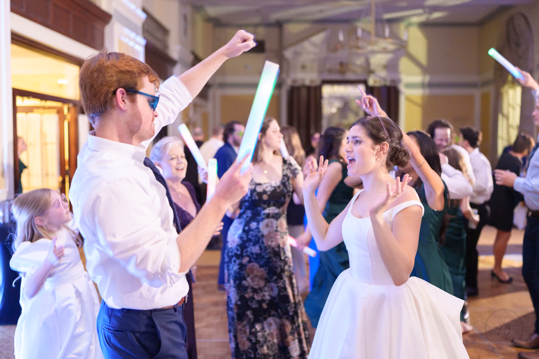 Bride dancing with a guest in sunglasses - Francis Marion Charleston