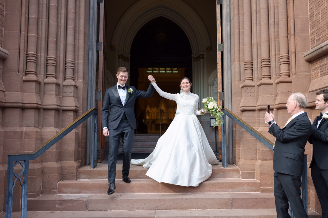 Happy couple walking out of the cathedral - Cathedral of Saint John Charleston