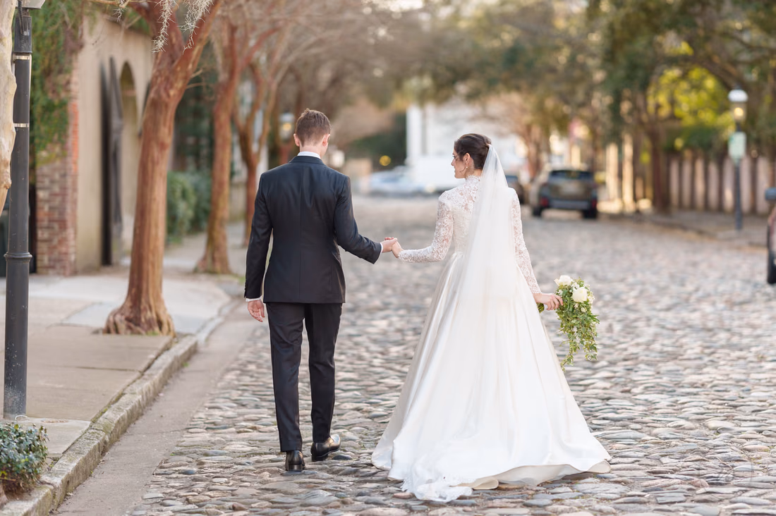 Holding hands walking away down the cobblestone street - Chalmers Street