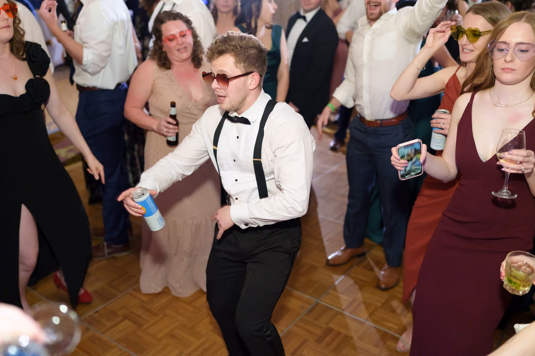 Guest in sunglasses dancing with a drink in hand - Francis Marion Charleston