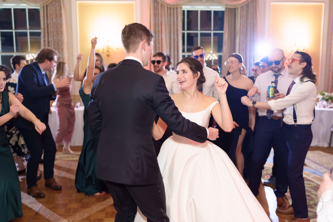 Groom dancing with the bride as friends cheer around them - Francis Marion Charleston