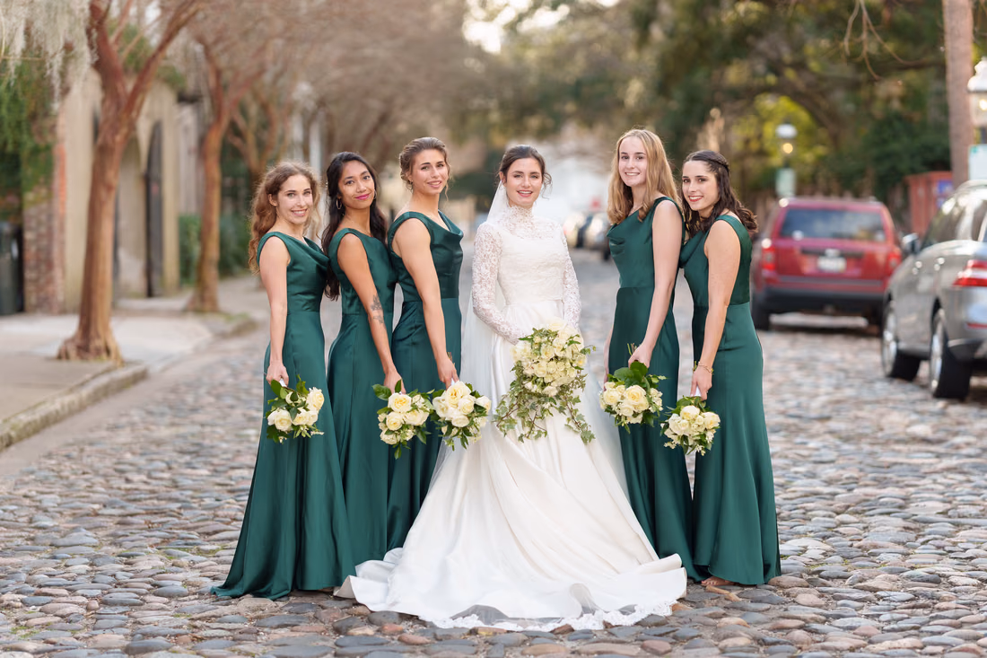 Bride and bridesmaids holding their bouquets on the cobblestone street - Chalmers Street