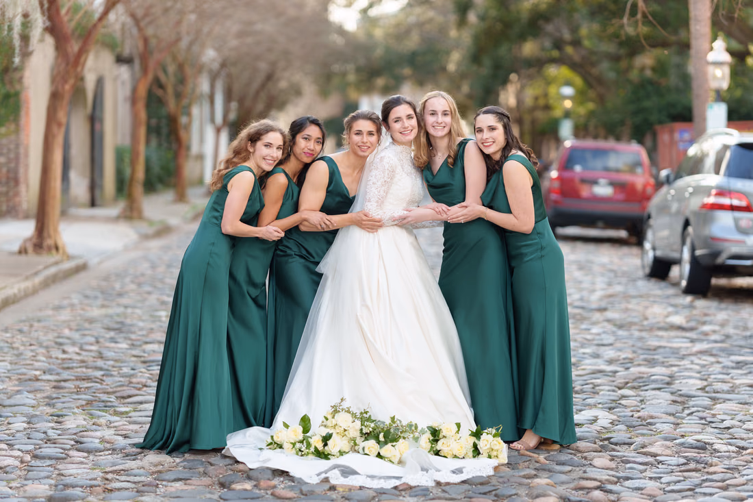 Bridesmaids leaning in around the bride with bouquets on her train - Chalmers Street