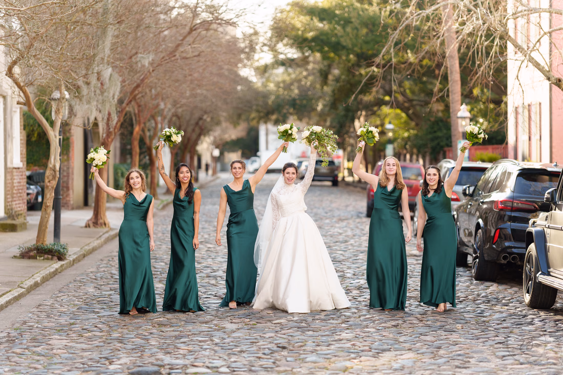 Bride and bridesmaids raising their bouquets in the middle of the street - Chalmers Street