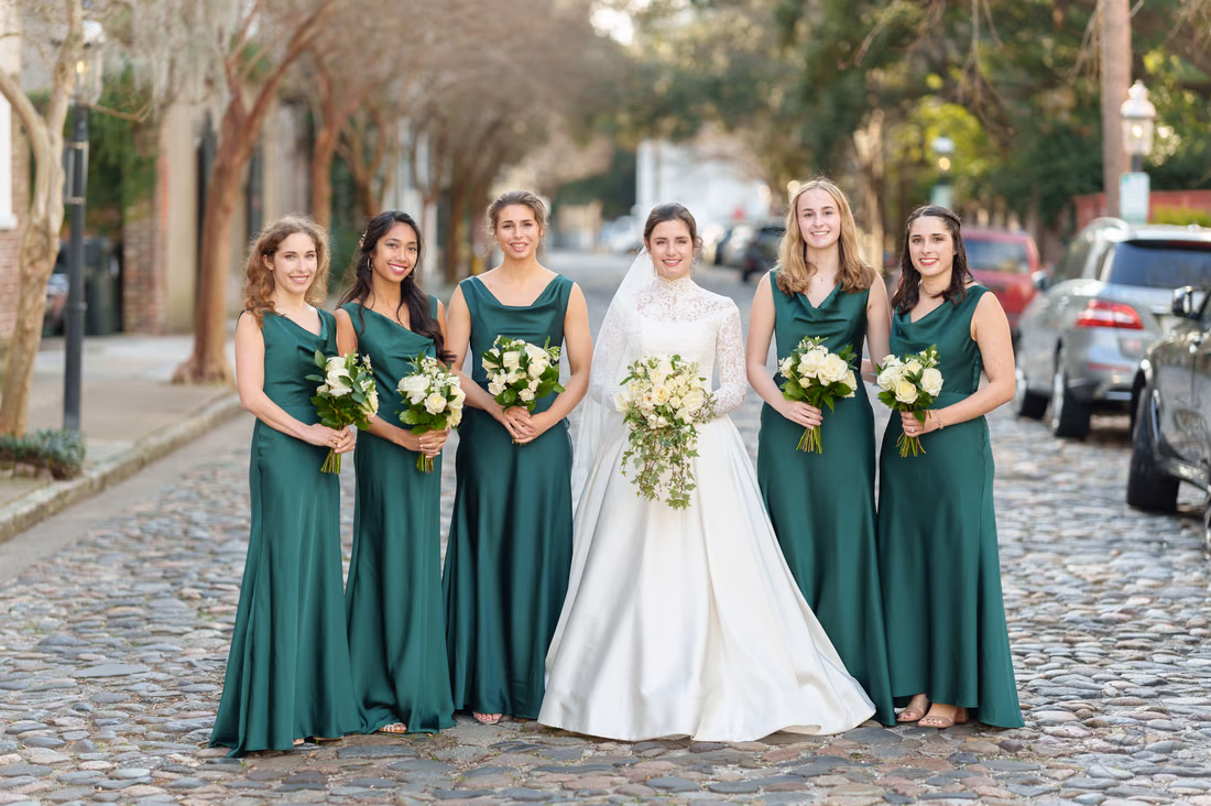 Bride and bridesmaids standing in a line on the cobblestones - Chalmers Street