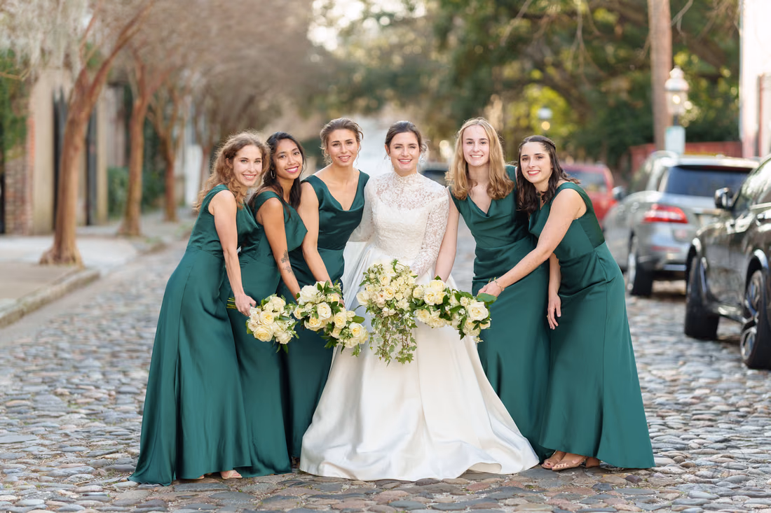 Bridesmaids leaning in with their bouquets together around the bride - Chalmers Street