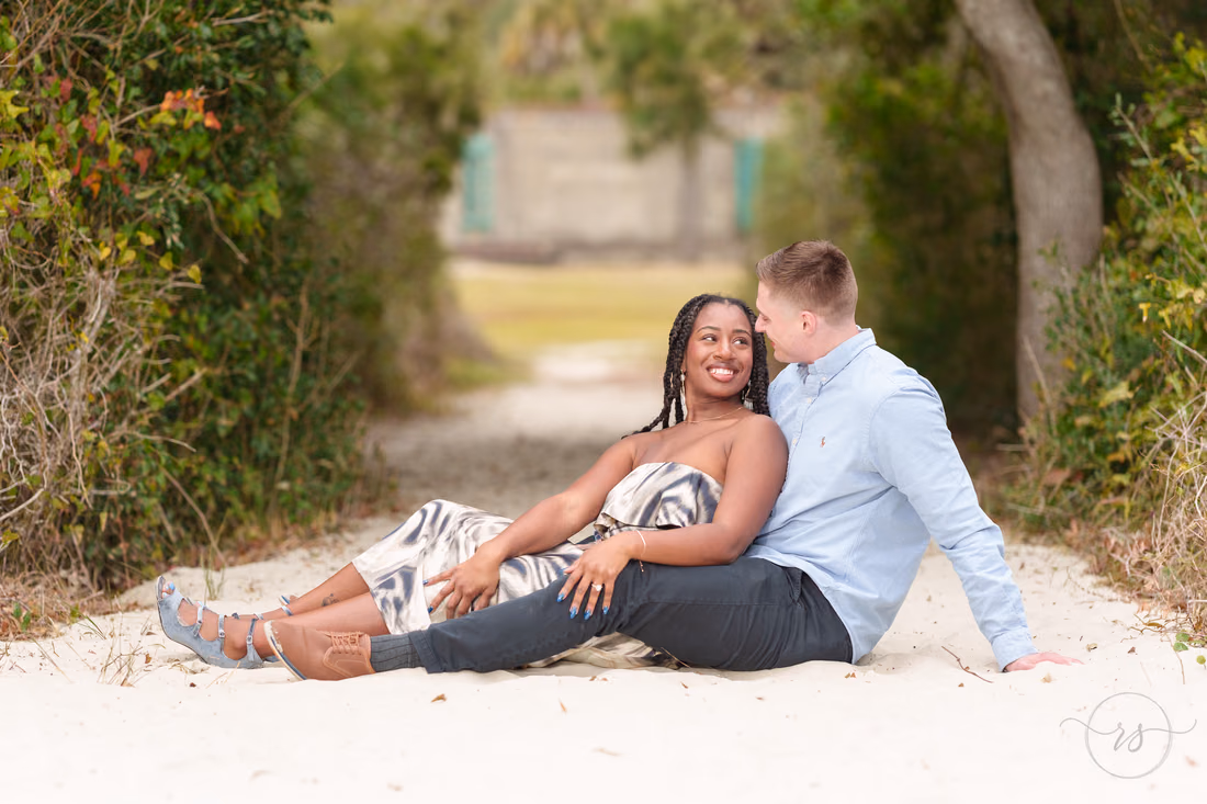 Couple sitting together on the sandy beach path near Atalaya Castle - Huntington Beach State Park