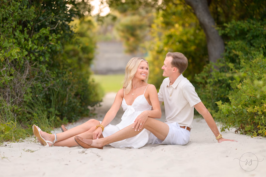 Couple sitting together on the sandy beach path - Huntington Beach State Park