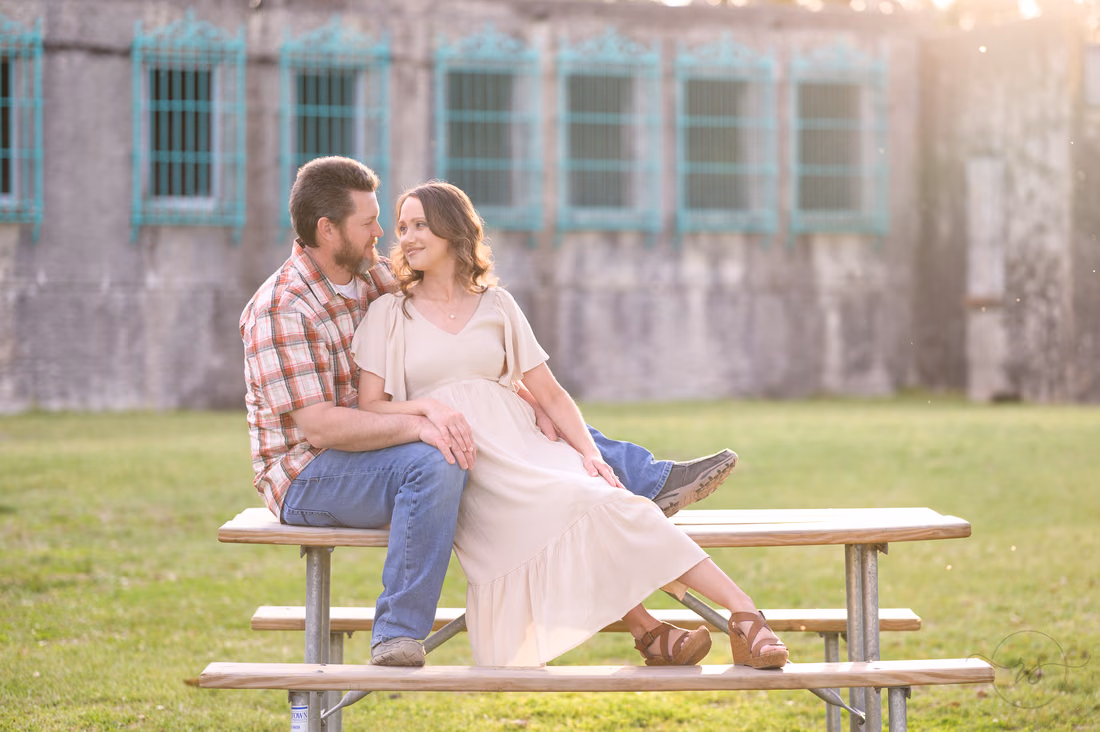 Couple sitting on a picnic table in front of Atalaya Castle - Huntington Beach State Park