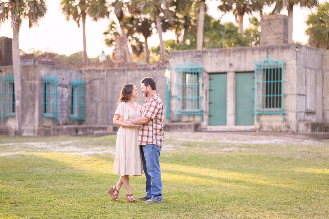 Couple hugging on the courtyard lawn of Atalaya Castle - Huntington Beach State Park