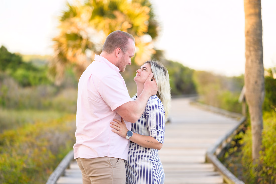 Couple embracing on the boardwalk to the beach - Myrtle Beach State Park