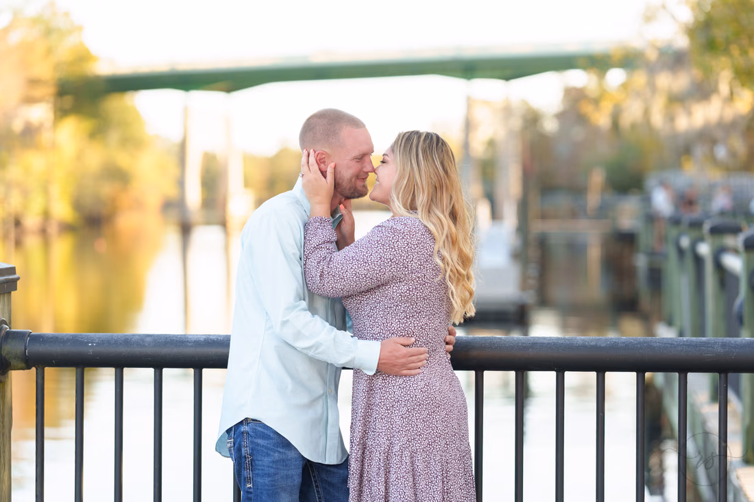 Couple about to kiss at the railing by the Waccamaw River - Conway River Walk