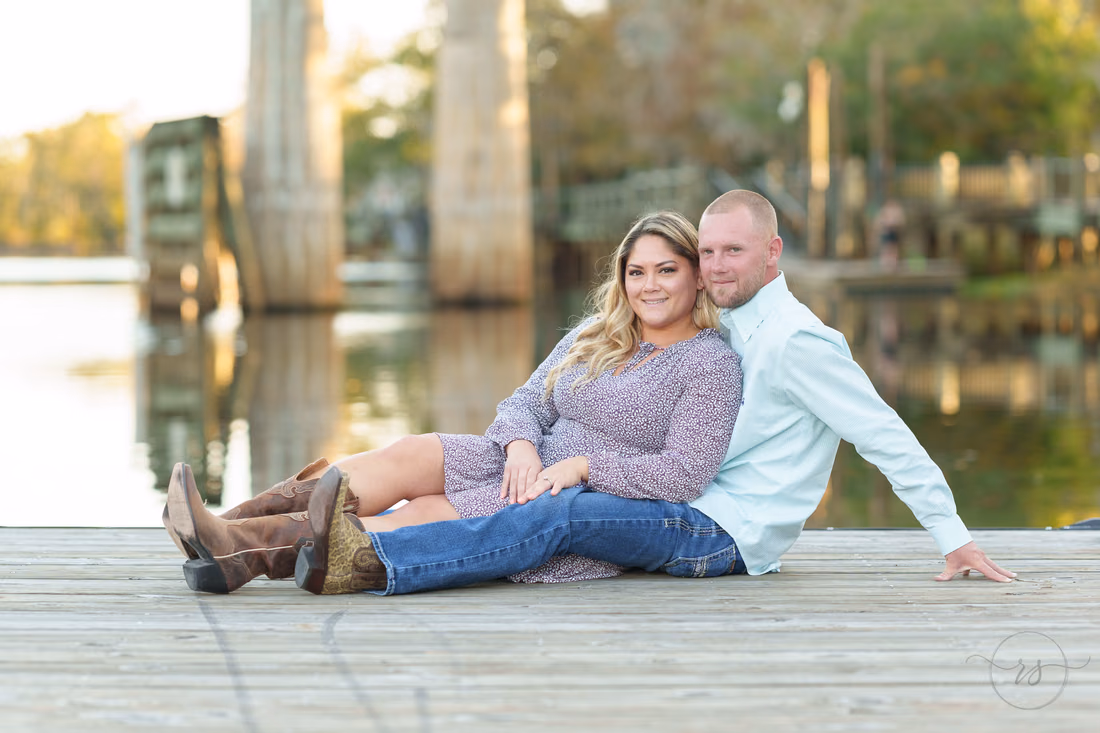 Couple in cowboy boots sitting on the dock by the Waccamaw River - Conway River Walk