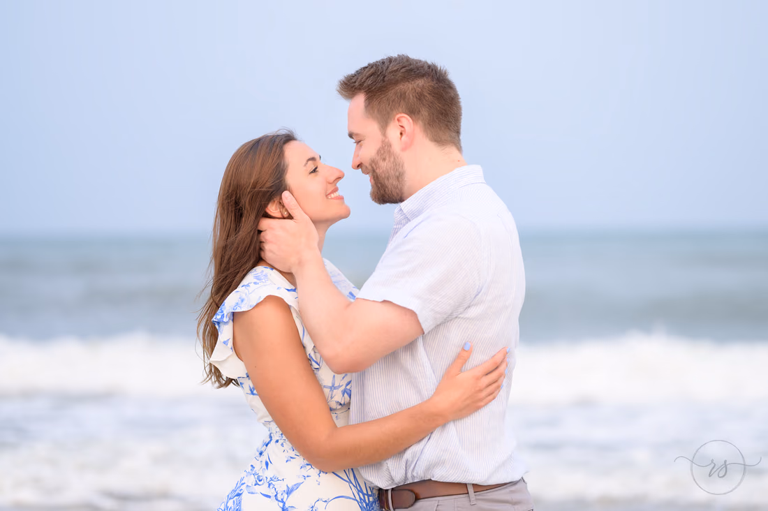 Couple nose to nose by the ocean - Huntington Beach State Park