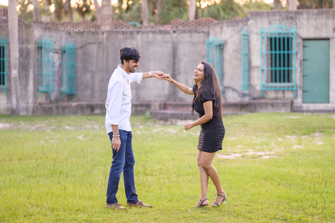 He twirls her on the lawn in front of Atalaya Castle - Huntington Beach State Park