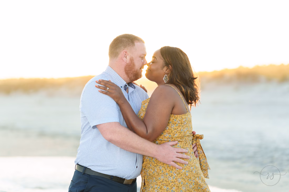 Couple nose to nose with the sun setting over the dunes - Huntington Beach State Park