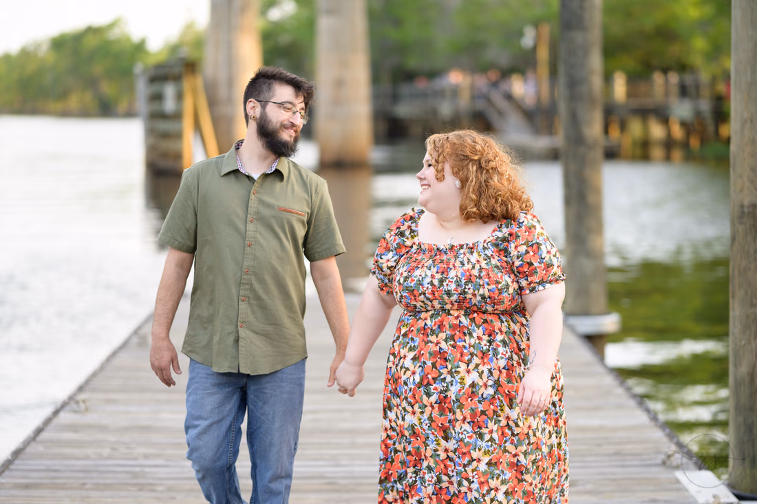 Happy couple walking by the water - Conway Riverwalk
