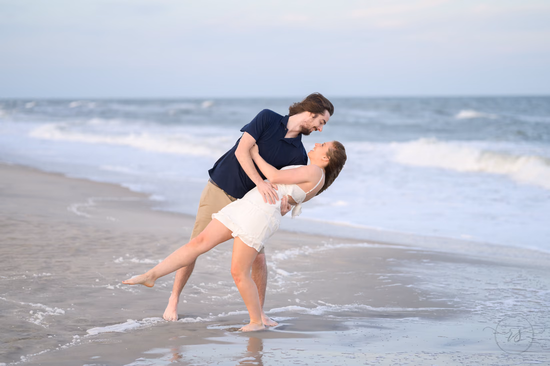 He dips her back in the shallow water - Huntington Beach State Park