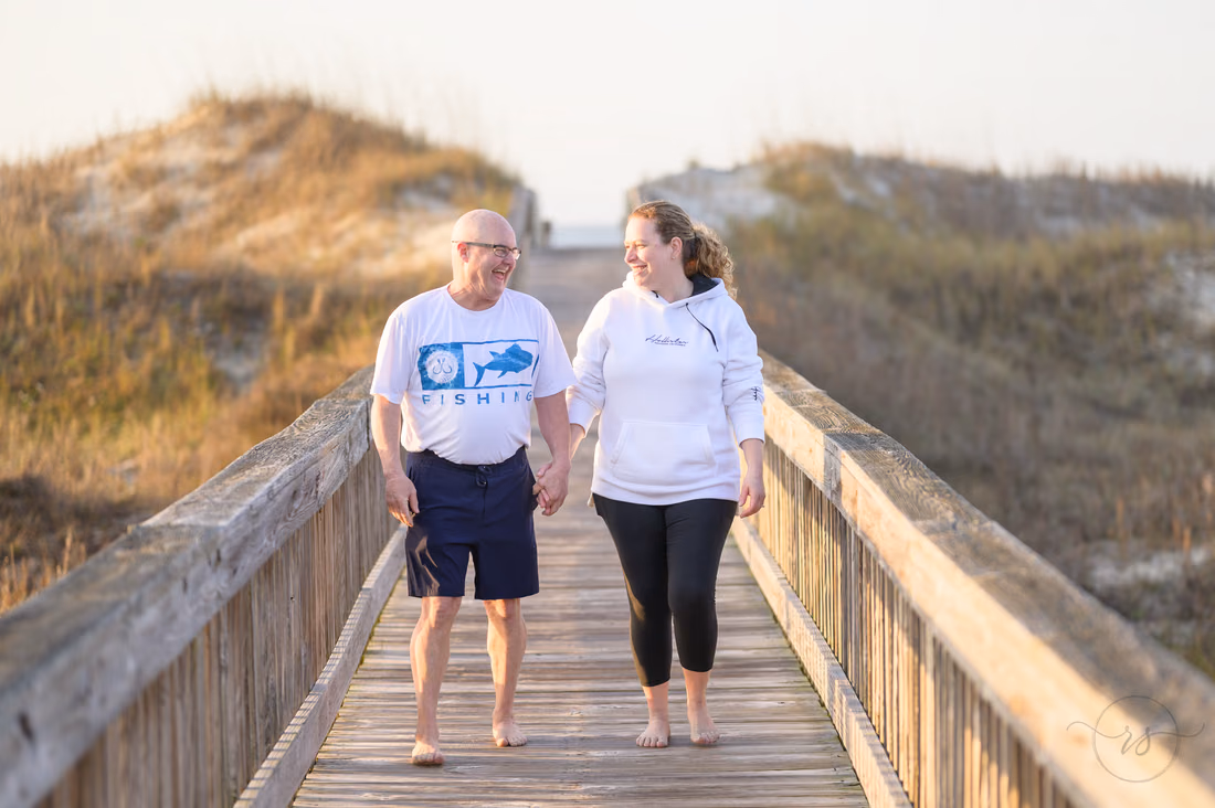Older couple walking down the beach access boardwalk - Ocean Isle