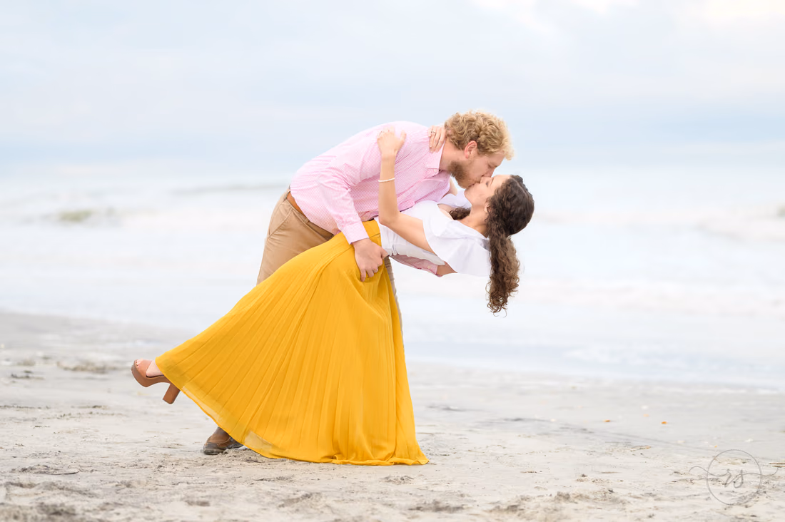 He dips her back for a kiss, her yellow skirt flowing - Huntington Beach State Park